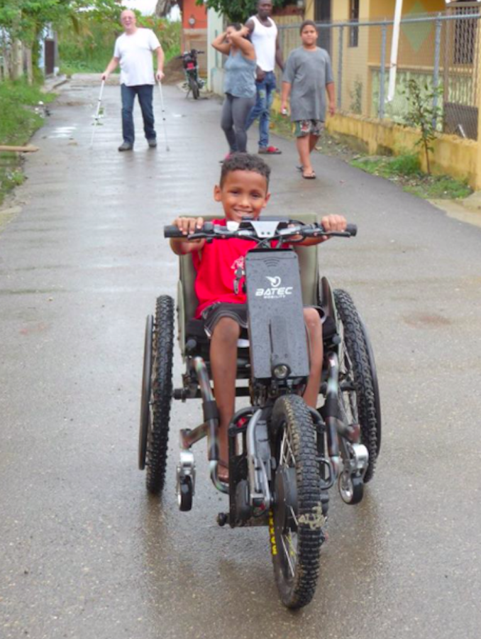 Child in Dominican Republic playing in my wheelchair